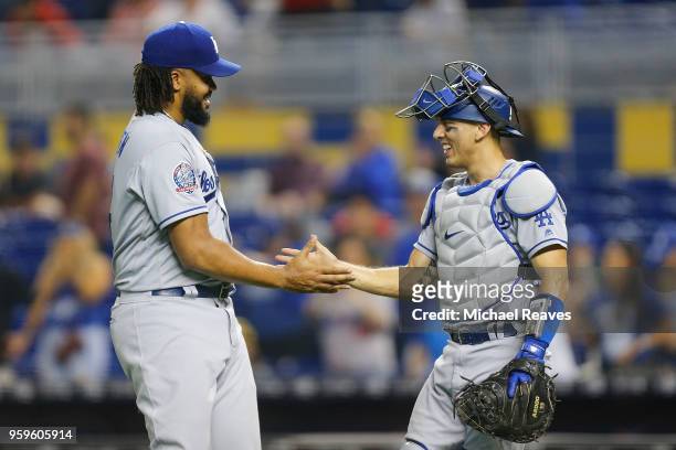 Kenley Jansen of the Los Angeles Dodgers shakes hands with Austin Barnes after they defeated the Miami Marlins 7-0 at Marlins Park on May 17, 2018 in...