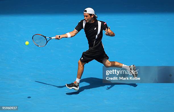 Albert Montanes of Spain plays a forehand in his third round match against Roger Federer of Switzerland during day six of the 2010 Australian Open at...