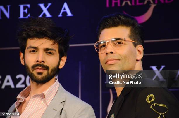 Bollywood movie star Kartik Aaryan and director Karan Johar pose for photographers after a press conference by Wizcraft to announce the 19th Edition...