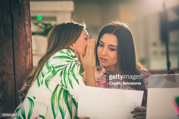 office coworkers whispering - gossip stock pictures, royalty-free photos & images