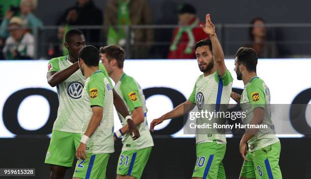Yunus Malli of Wolfsburg celebrates after scoring his team's third goal with team mates during the Bundesliga Playoff Leg 1 match between VfL...