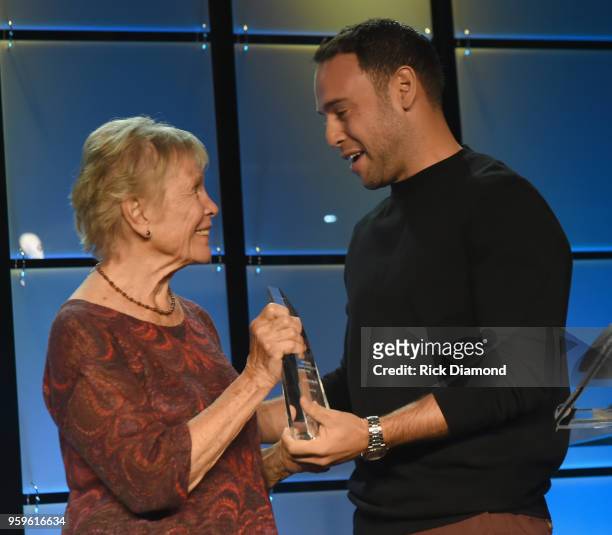 Sandra Chapin presents an award to owner of School Boy Records and RBMG, Scooter Braun and take photos before the Music Biz 2018 Awards Luncheon for...