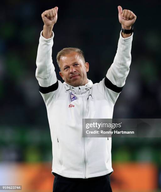 Head coach Markus Anfang of Holstein Kiel applauds the fans after the Bundesliga Playoff Leg 1 match between VfL Wolfsburg and Holstein Kiel at...