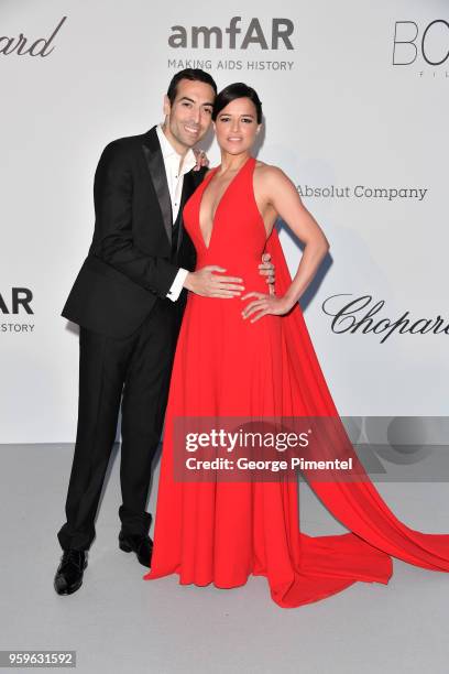 Mohammed Al Turki and Michelle Rodriguez arrive at the amfAR Gala Cannes 2018 at Hotel du Cap-Eden-Roc on May 17, 2018 in Cap d'Antibes, France.