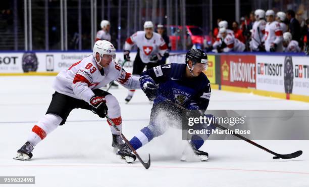 Markus Nutivaara of Finland and Joel Vermin of Switzerland battle for the puck during the 2018 IIHF Ice Hockey World Championship Quarter Final game...