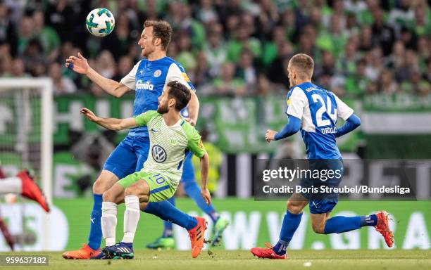 Dominic Peitz of Holstein Kiel in action with Yunus Malli of VfL Wolfsburg during the Bundesliga Playoff Leg 1 match between VfL Wolfsburg and...