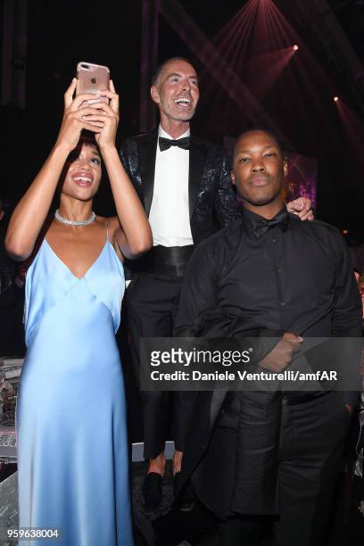 Corey Hawkins, Dan Caten and Laura Harrier attend the amfAR Gala Cannes 2018 dinner at Hotel du Cap-Eden-Roc on May 17, 2018 in Cap d'Antibes, France.