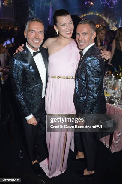 Dean Caten, Milla Jovovich and Dan Caten attend the amfAR Gala Cannes 2018 dinner at Hotel du Cap-Eden-Roc on May 17, 2018 in Cap d'Antibes, France.