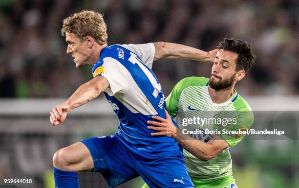 Johannes van den Bergh of Holstein Kiel action with Yunus Malli of VfL Wolfsburg during the Bundesliga Playoff Leg 1 match between VfL Wolfsburg and...