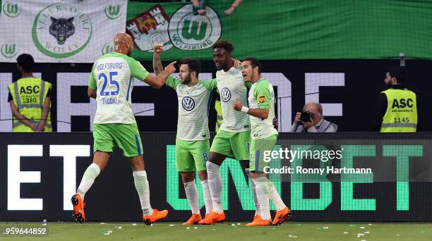 Divock Origi of Wolfsburg celebrates after scoring his team's opening goal with John Anthony Brooks , Renato Steffen and William during the...