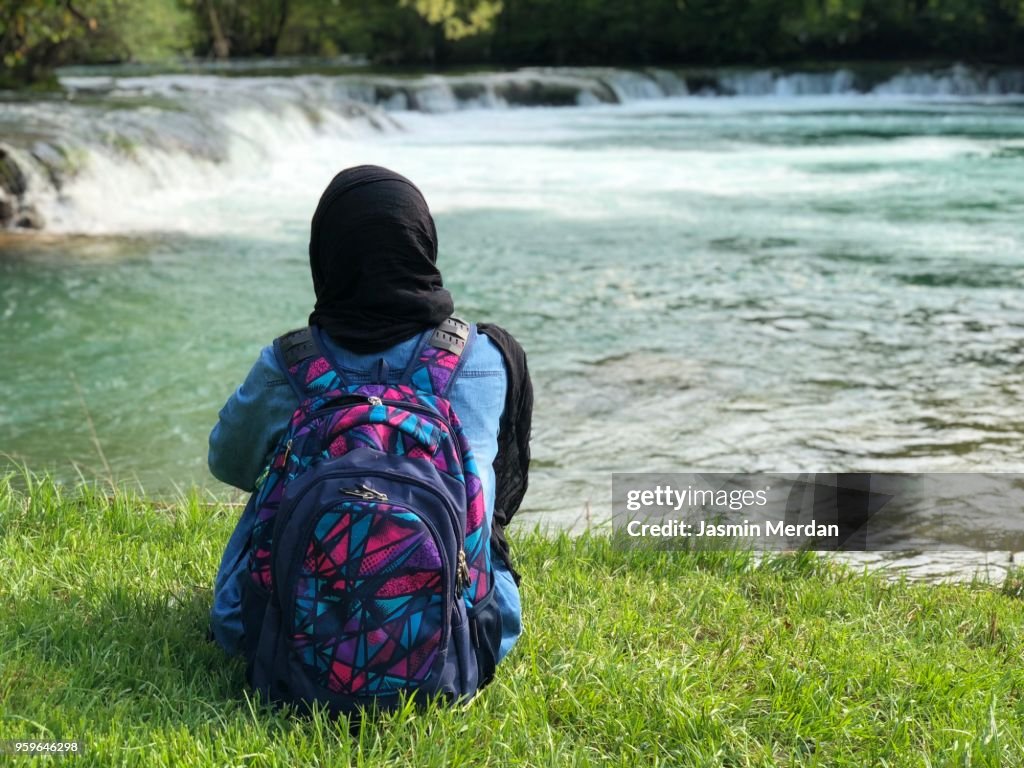 Muslim woman on river during travel