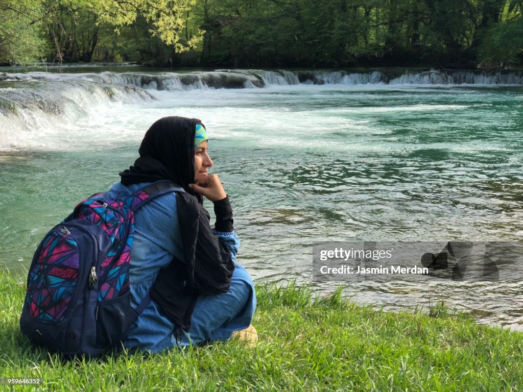 Muslim woman on river during travel