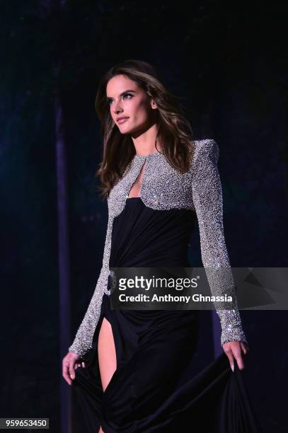 Alessandra Ambrosio, wearing Balmain, walks the runway at the amfAR Gala Cannes 2018 dinner at Hotel du Cap-Eden-Roc on May 17, 2018 in Cap...