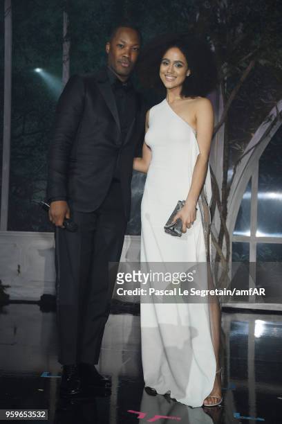 Corey Hawkins and Laura Harrier speak on stage at amfAR Gala Cannes 2018 dinner at Hotel du Cap-Eden-Roc on May 17, 2018 in Cap d'Antibes, France.