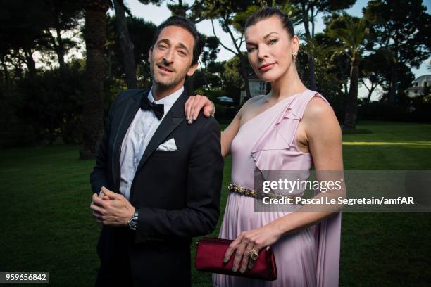 Adrien Brody and Milla Jovovich pose for portraits at the amfAR Gala Cannes 2018 cocktail at Hotel du Cap-Eden-Roc on May 17, 2018 in Cap d'Antibes,...