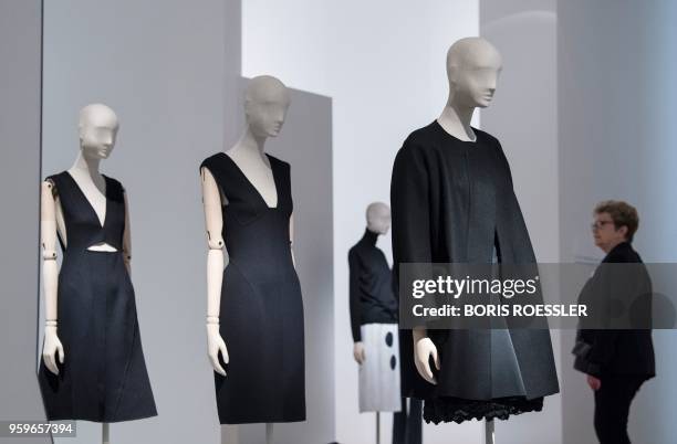 Picture taken on on November 2, 2017 shows a woman looking at exhibits of the exhibition "Jil Sander" in the 'Museum of Applied Art' in Frankfurt am...