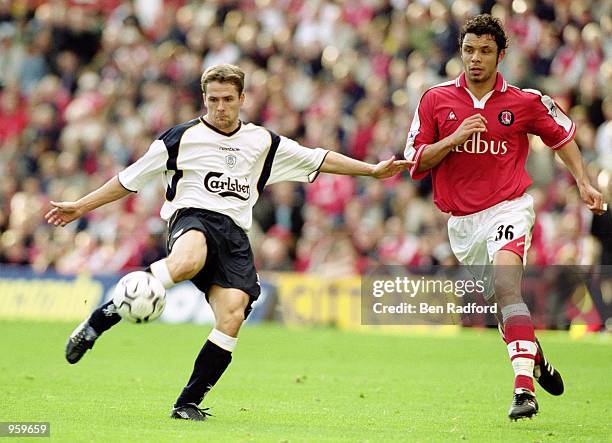 Michael Owen of Liverpool shoots past Mark Fish of Charlton Athletic during the FA Barclaycard Premiership match between Charlton Athletic and...