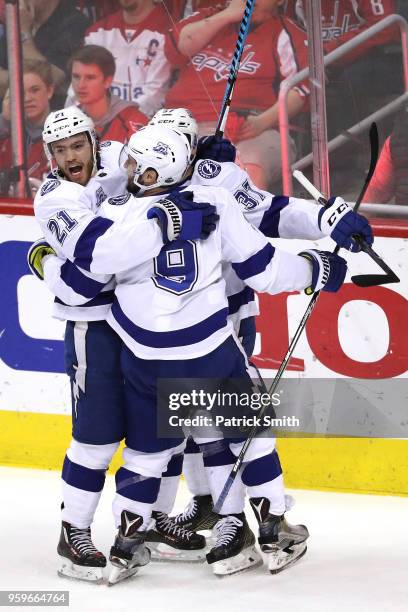 Brayden Point of the Tampa Bay Lightning celebrates with his teammates Tyler Johnson and Yanni Gourde after scoring a goal on Braden Holtby of the...