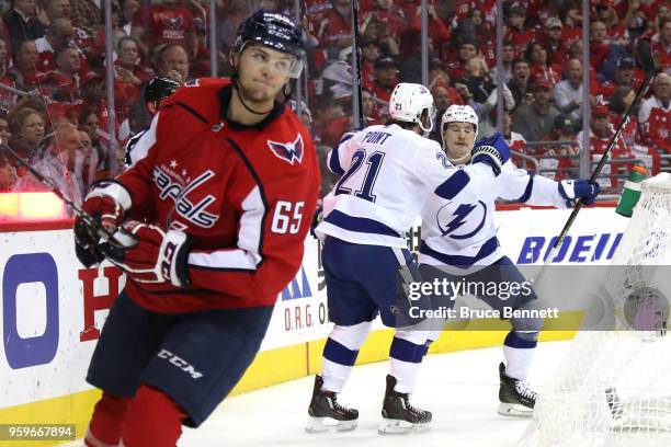 Brayden Point of the Tampa Bay Lightning celebrates with his teammates Tyler Johnson and Yanni Gourde after scoring a goal on Braden Holtby of the...