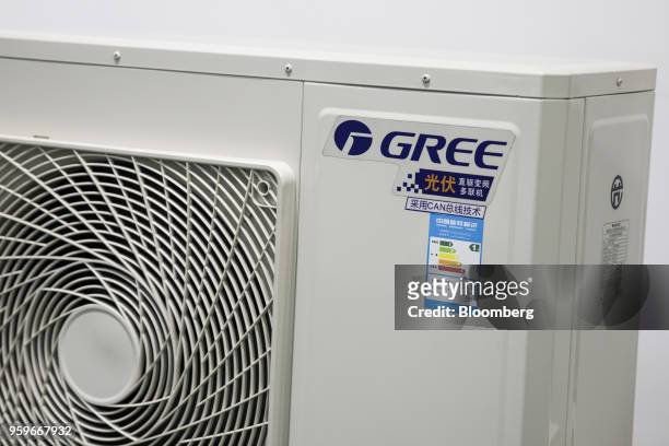 The logo of Gree Electric Appliances Ltd. Is displayed on the outdoor unit of a commercial air conditioner at the company's showroom in Zhuhai,...