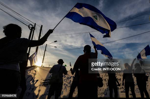 People flutter Nicaraguan national flags during a protest of the "Madres de Abril" movement in demand of justice for their sons -killed during the...