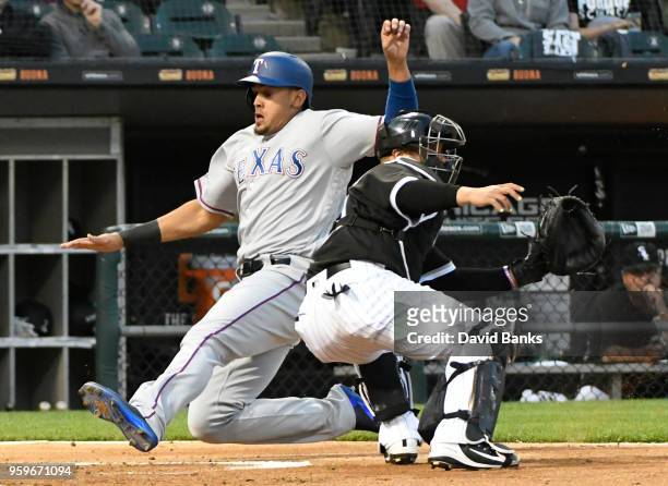 Ronald Guzman of the Texas Rangers is safe at home as Welington Castillo of the Chicago White Sox waits for the throw during the third inning on May...
