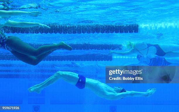 Swimmers warm up before the start of the final races during the TYR Pro Swim Series at Indiana University Natatorium on May 17, 2018 in Indianapolis,...