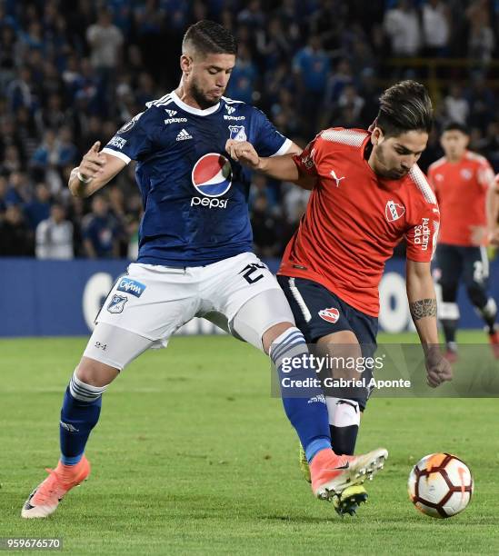 Matias De Los Santos of Millonarios vies for the ball with Martin Benitez of Independiente during a match between Millonarios and Independiente as...