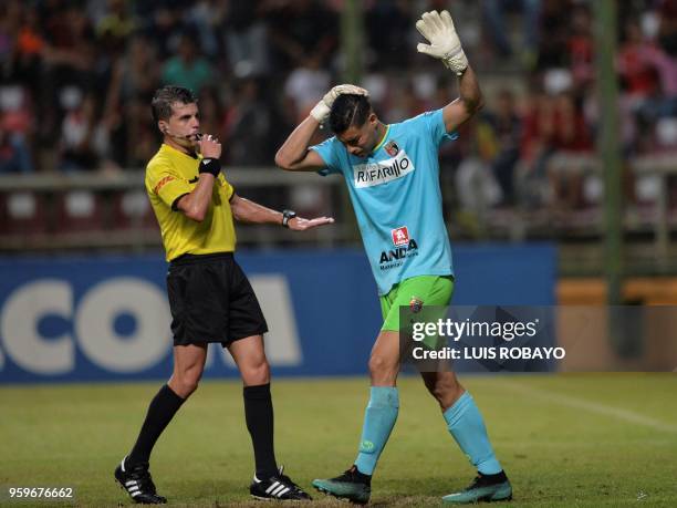 Venezuela's Deportivo Lara goalkeeper Luis Curiel reacts a Lara fans throw objects to the field during their Copa Libertadores football match against...