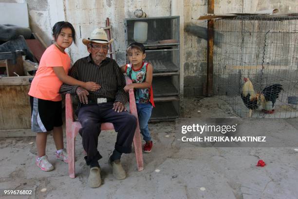 Mexican Manuel Garcia Hernandez, who claims to be 121 years old, sits with her great-granddaughters at his home in Ciudad Juarez, Chihuahua state,...