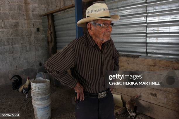 Mexican Manuel Garcia Hernandez, who claims to be 121 years old, stands next to his rooster and chicken hen at his home in Ciudad Juarez, Chihuahua...