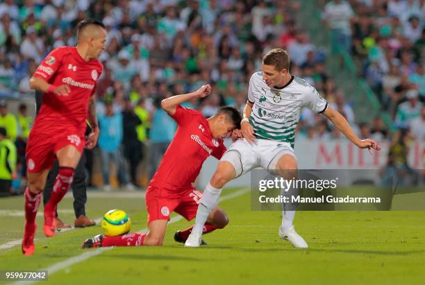 Julio Furch fo Santos and Pablo Barrientos of Toluca fight for the ball during the Final first leg match between Santos Laguna and Toluca as part of...