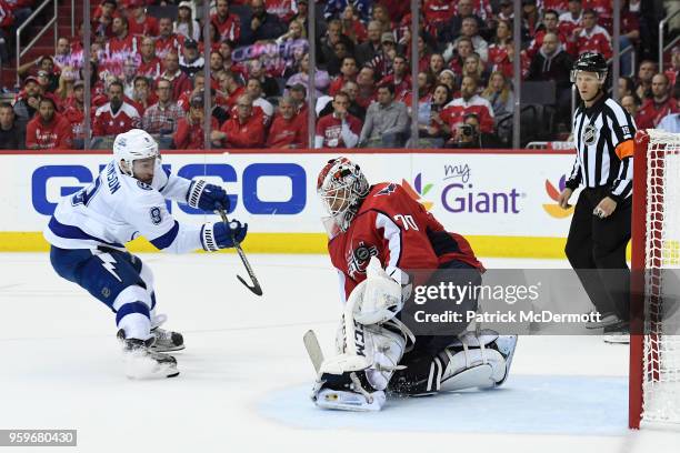 Braden Holtby of the Washington Capitals makes a save against Tyler Johnson of the Tampa Bay Lightning in the second period in Game Four of the...