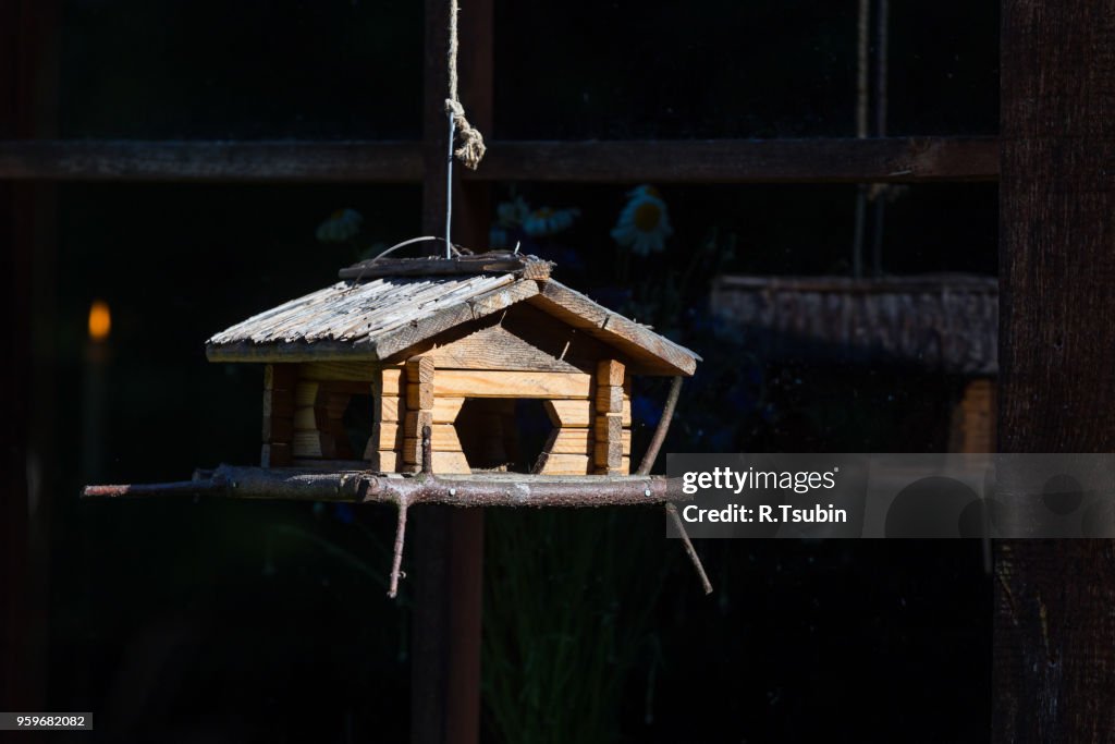 Handcrafted log cabin birdhouse feeder. Close up