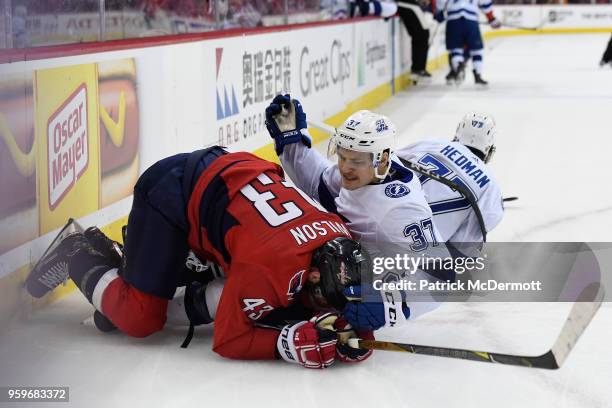 Yanni Gourde of the Tampa Bay Lightning and Tom Wilson of the Washington Capitals collide in the first period in Game Four of the Eastern Conference...