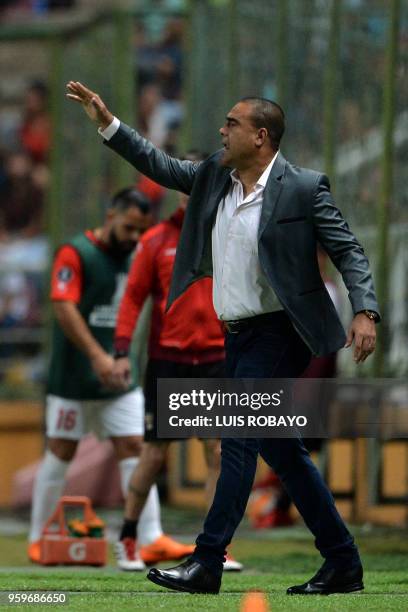 Venezuela's Deportivo Lara coach Leonardo Gonzalez gives instructions to his players during their Copa Libertadores football match against Brazil's...