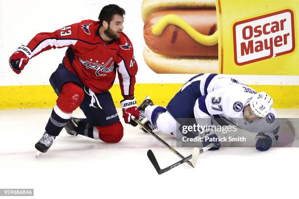 Tom Wilson of the Washington Capitals and Yanni Gourde of the Tampa Bay Lightning collide during the first period in Game Four of the Eastern...