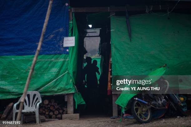 In this picture taken on May 12 an internally displaced woman with a child are seen at a temporary shelter in Danai, Kachin state. - Often called the...