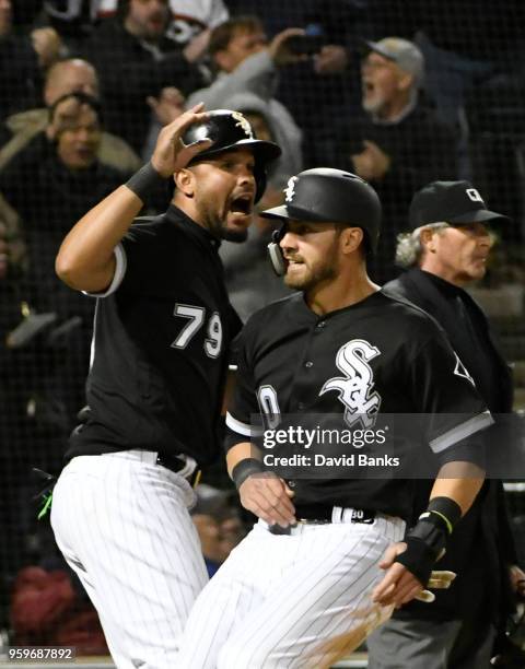 Jose Abreu of the Chicago White Sox and Nicky Delmonico of the Chicago White Sox celebrate after scoring against the Texas Rangers during the eighth...