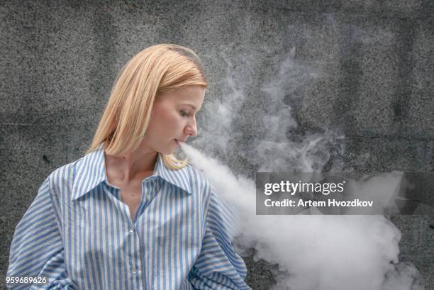 young female smoking electronic cigarette - cartomizer stock pictures, royalty-free photos & images