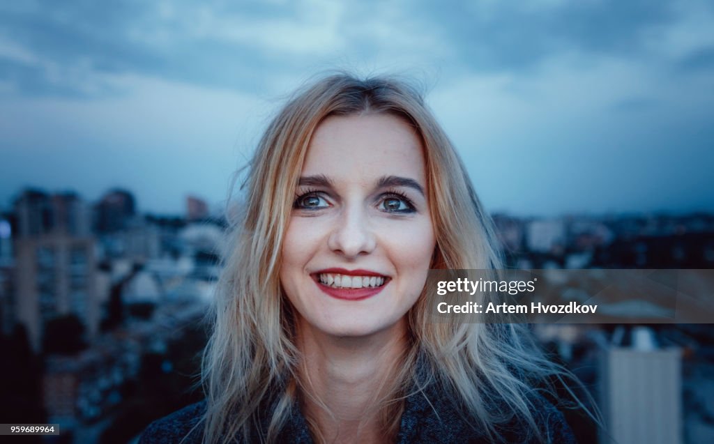 Young blond haired woman smiling and looking aside