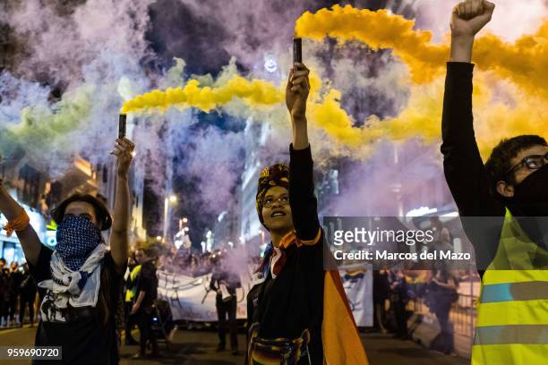 People protesting with colored smoke during the International Day Against Homophobia, Transphobia and Biphobia to demand equality for LGBT community.