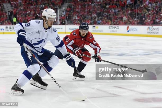 Mikhail Sergachev of the Tampa Bay Lightning skates with the puck against Andre Burakovsky of the Washington Capitals in the second period in Game...