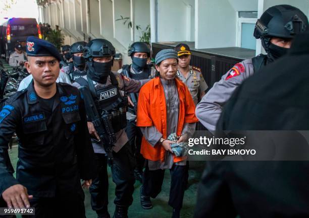 Armed police escort Aman Abdurrahman, leader of the Islamic State group -linked militant outfit Jamaah Ansharut Daulah, to a court hearing for the...