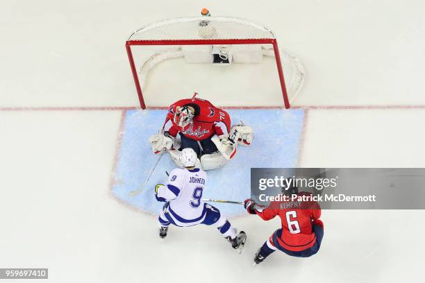 Braden Holtby of the Washington Capitals follows the puck in front of Tyler Johnson of the Tampa Bay Lightning in the first period in Game Three of...