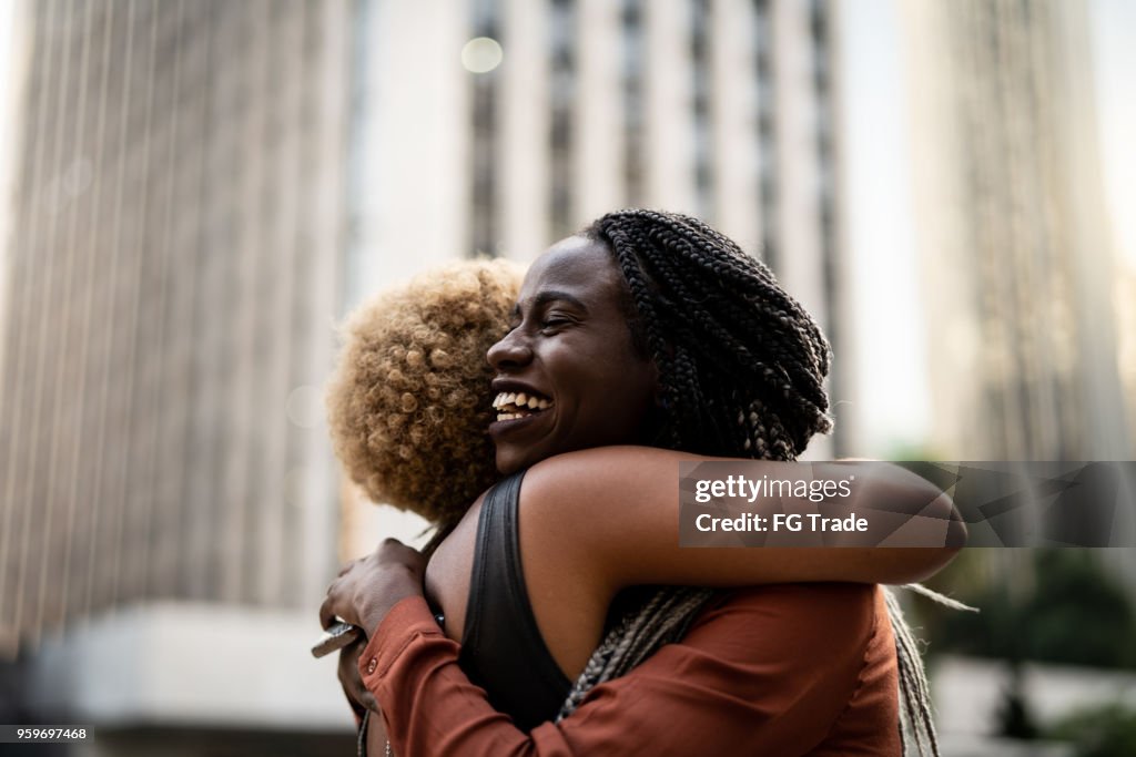 Business woman/students embracing