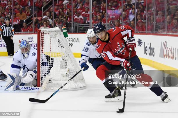 Alex Chiasson of the Washington Capitals controls the puck against J.T. Miller of the Tampa Bay Lightning in the first period in Game Three of the...