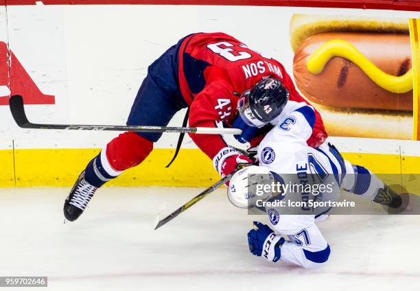 Washington Capitals right wing Tom Wilson battles with Tampa Bay Lightning center Yanni Gourde during game four of the NHL Eastern Conference Finals...