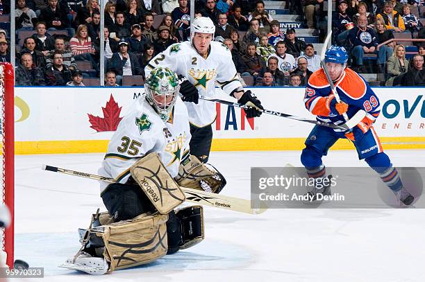 Sam Gagner of the Edmonton Oilers and Nicklas Grossman of the Dallas Stars watch Marty Turco make a right pad save on January 22, 2010 at Rexall...