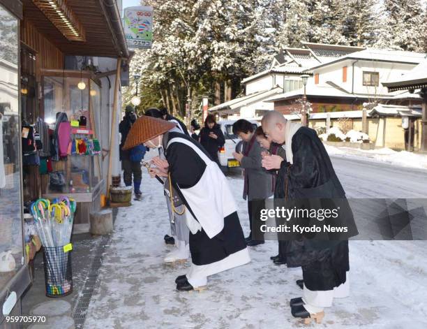 Buddhist monks from the Koyasan Shingon Sect bow in Koya, Wakayama Prefecture, on Jan. 24 during an event held to seek donations. The approximately...